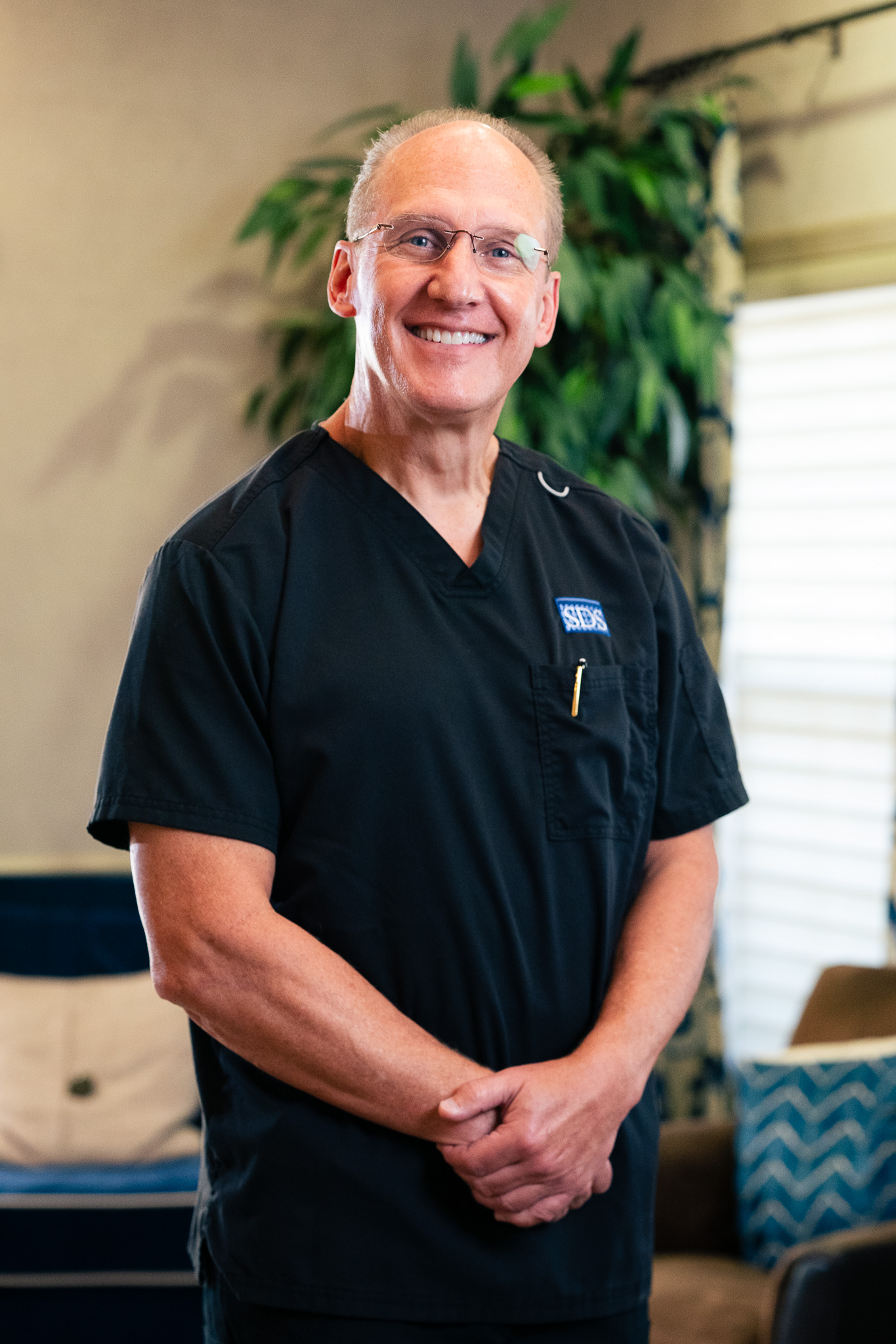 Meet Dr. Steven D. Strickland, Woodbridge, VA Dentist Dr. Steven D. Strickland, a Woodbridge, VA dentist and Fellow of the Academy of General Dentistry, smiling in dark scrubs at his office